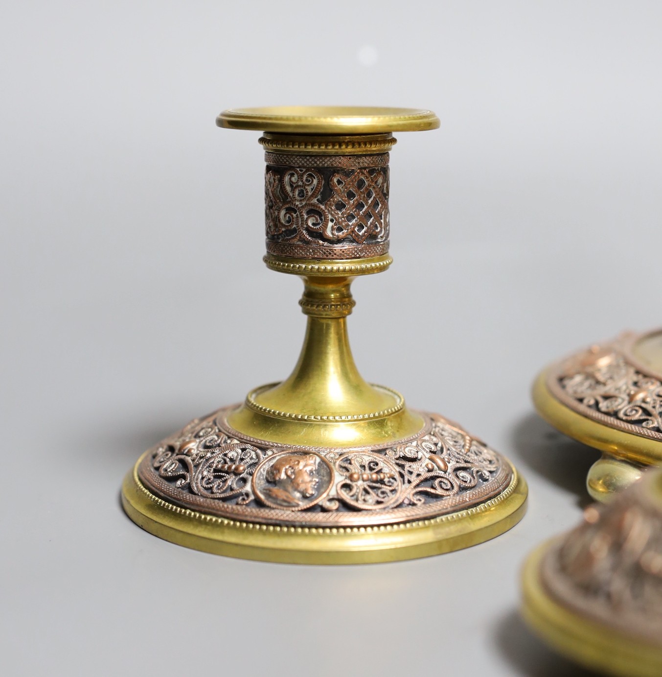 A brass and filigree worked copper desk set (4), inkwell 10.5 cms high